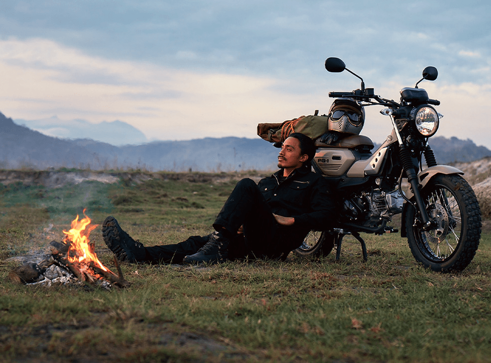 man leaning on his bike